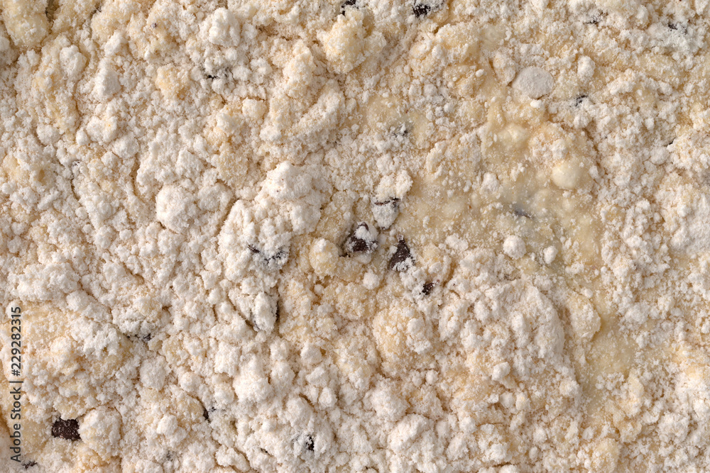 Top view of clumpy chocolate chip muffin mix with milk added. Top view of clumpy chocolate chip muffin mix with milk added.
