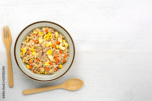 fried rice with tuna and vegetable in a ceramic dish, copy space for text. homemade style food concept.
