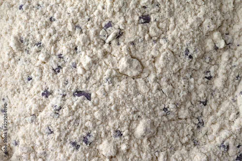 Very close view of clumpy blueberry muffin mix with imitation blueberries. Very close view of clumpy blueberry muffin mix with imitation blueberries.