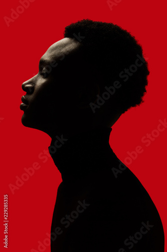 African American man portrait profile silhouette isolated over red - Eyes closed