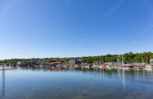 Wide view of the Belfast, Maine waterfront on a bright summer day. © Bert Folsom