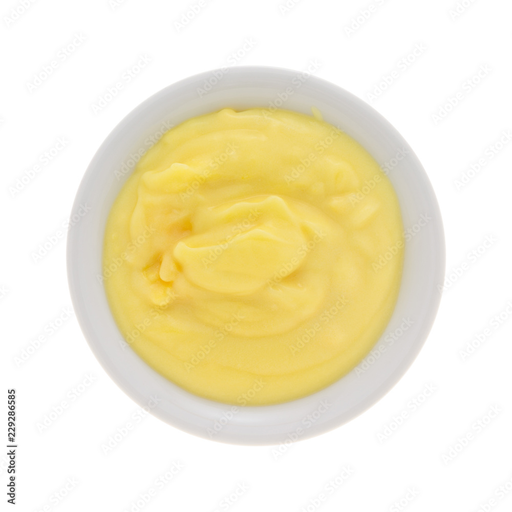 Top view of homemade banana cream pudding in a small bowl isolated on a white background. Top view of homemade banana cream pudding in a small bowl isolated on a white background.