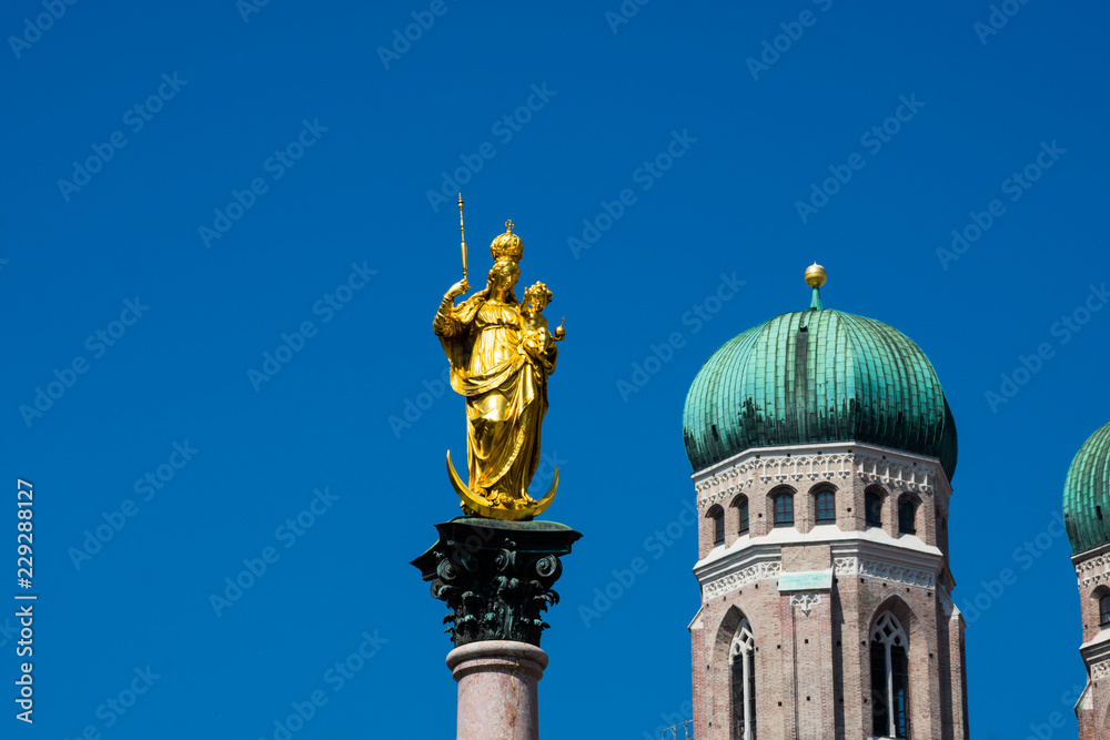 Mary's Column (Mariensaule) at Mary's Square (Marienplatz) Frauenkirche (Munich cathedral) in the background. Munich, Germany