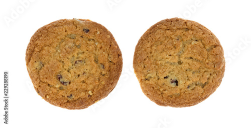 Top view of two cranberry and oat cookies isolated on a white background.