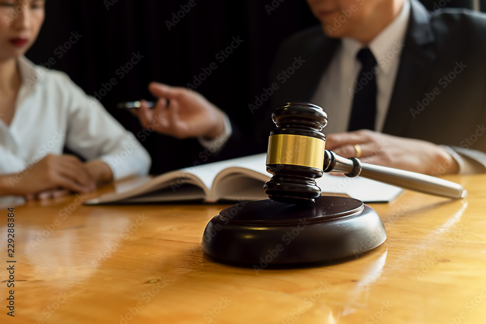 Judge gavel with Justice lawyers having team meeting at law firm background. Concepts of Law and Legal services. Judge gavel with Justice lawyers having team meeting at law firm background. Concepts of Law and Legal services.