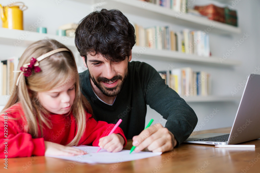 Little girl painting with her father at home. Little girl painting with her father at home.