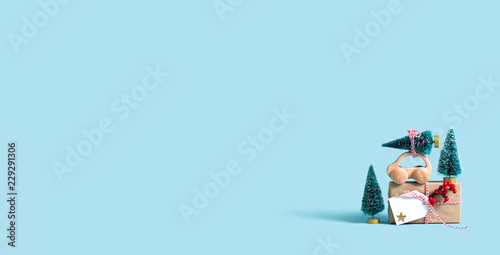 Toy car carrying a Christmas tree with a gift box