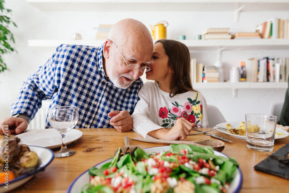 Grandfather and his granddaughter dining together at home. Grandfather and his granddaughter dining together at home.