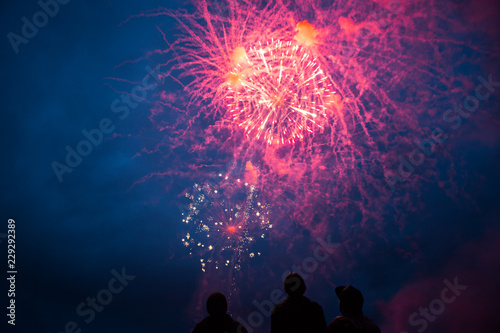 Fireworks celebration at night with friends watching photo