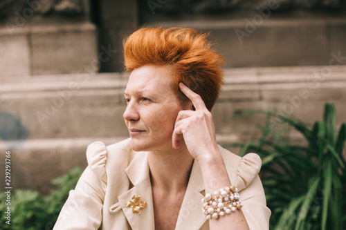 attractive woman of fifty years with red hair photo