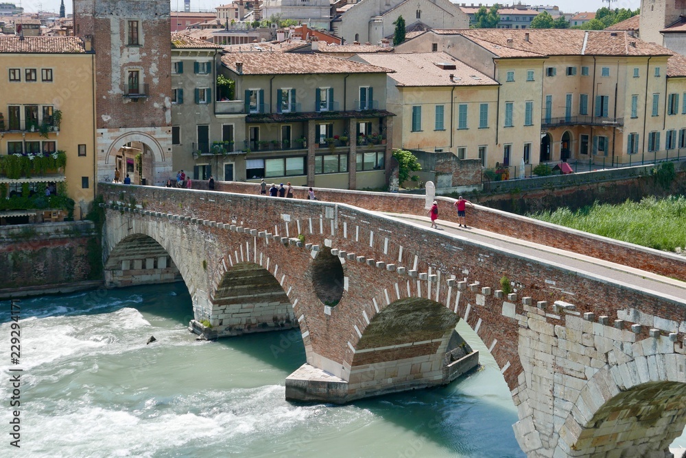 Old roman bridge across adige river in Verona