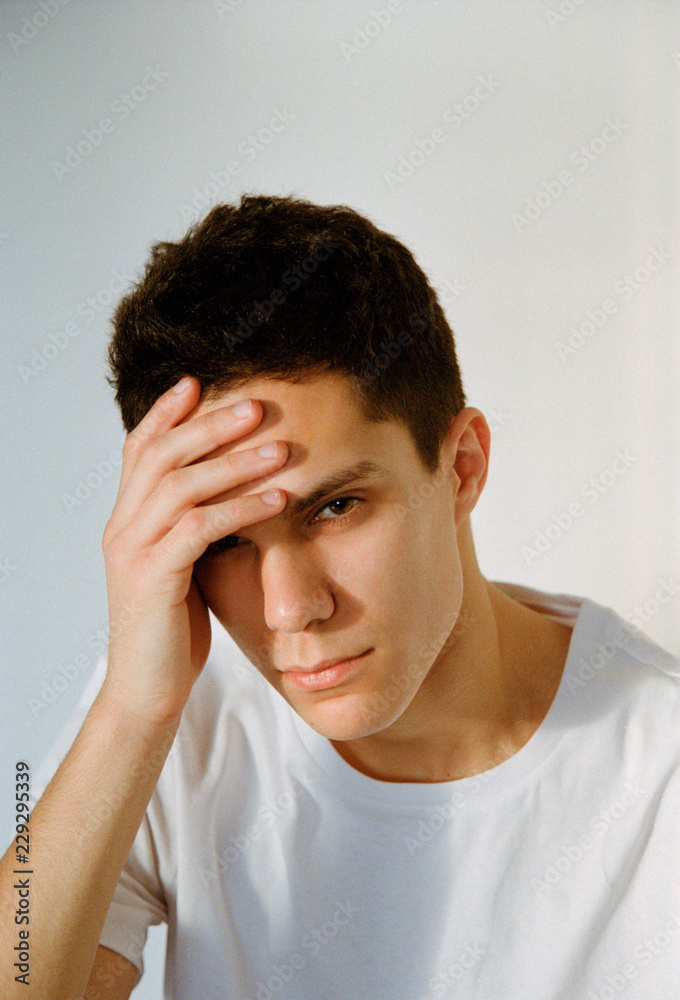 Young man holding head Young man holding head