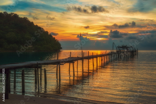 wooden pier at sunset on Koh Kood in Thailand.