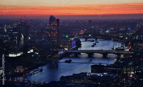 The skyline of London, England at sunset, including the River Thames, Tate Modern, and One Blackfriars.