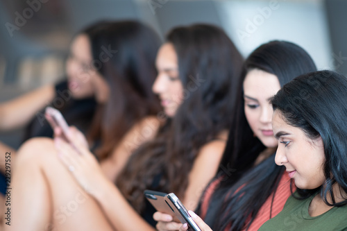 Teen Friends Using Their Phones