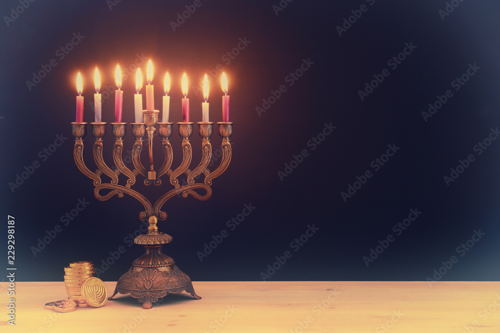 image of jewish holiday Hanukkah background with menorah (traditional candelabra) and candles.