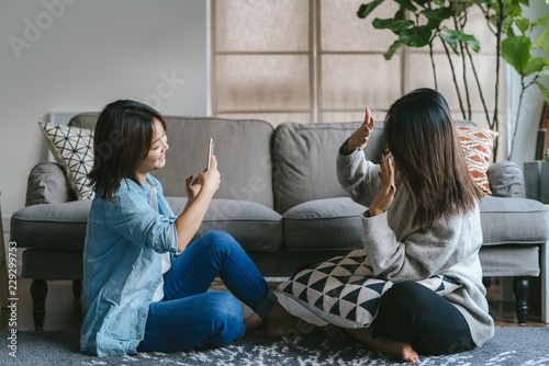 Two young female friends taking a picture photo