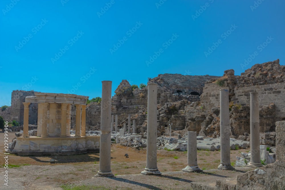 The ruins of the ancient Roman city of Side in Turkey. The remains of buildings, theater and other infrastructure of the ancient city. Historical monuments of ancient Greek and Roman eras.