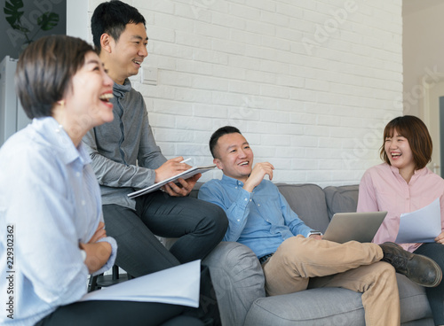 Businessman and businesswoman discussing in office photo