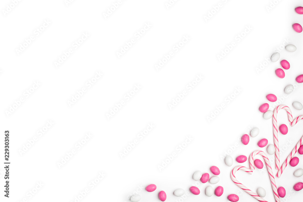 Frame Pink and White candies and lollipops Top view White Background Valentine's Day