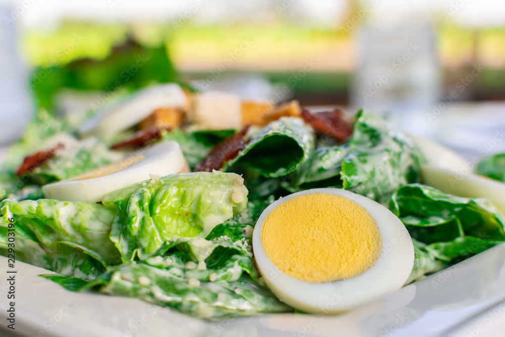 Fresh caesar salad with sliced boiled egg clean and healthy food. Fresh caesar salad with sliced boiled egg clean and healthy food.