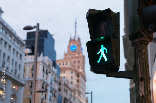 Glowing crosswalk semaphore on street photo