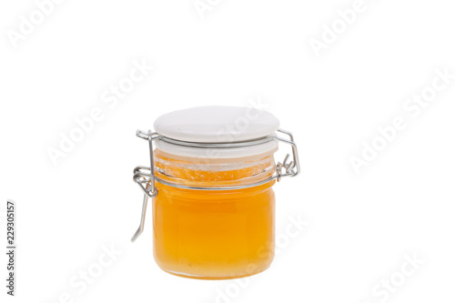 Sweet honey in jar isolated on white