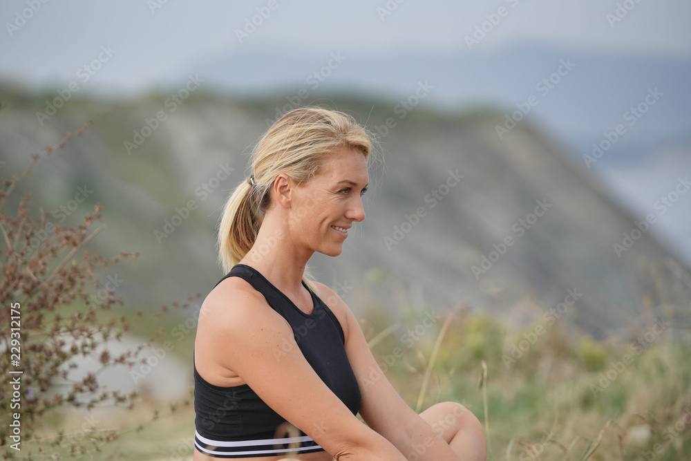 Woman training outside, doing stretching exercises Woman training outside, doing stretching exercises