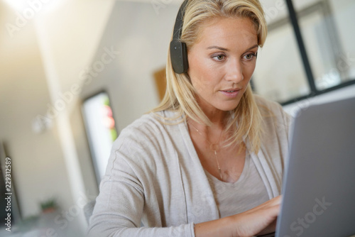 Businesswoman working from home-office, using headset