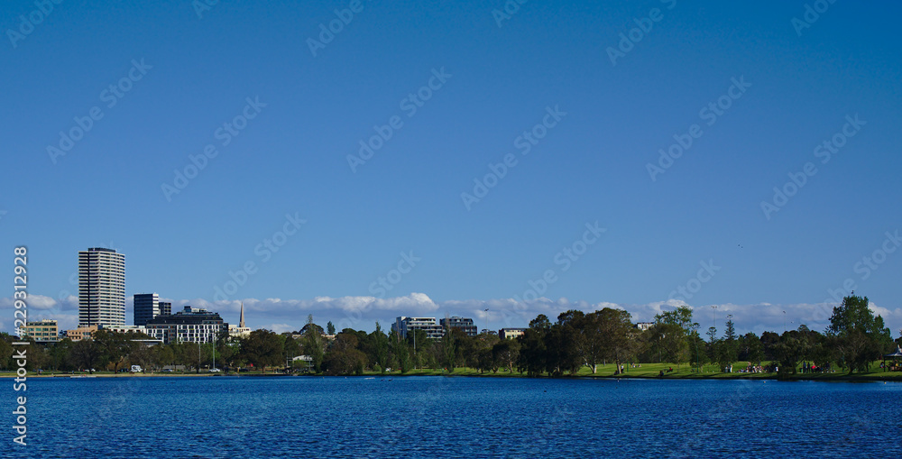 Distant view of skyline from a park lake