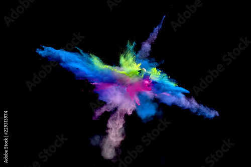 Multi Colored forms of powder paint and flour combined together explode in front of a black background to give off fantastic multi colored explosions.