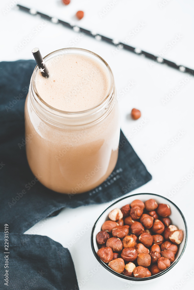 Nut butter chocolate protein shake in a glass jar. The concept of a healthy lifestyle and fitness diet. Nut butter chocolate protein shake in a glass jar. The concept of a healthy lifestyle and fitness diet.