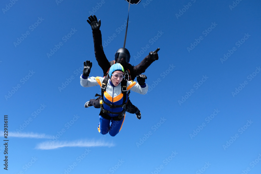 Skydiving. Tandem jump for emotional pretty girl.