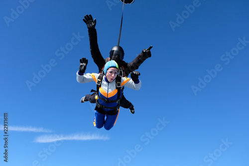 Skydiving. Tandem jump for emotional pretty girl.
