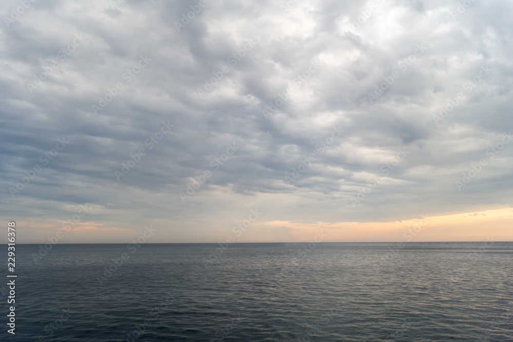 Cloudy sunset over the Black Sea in summer evening