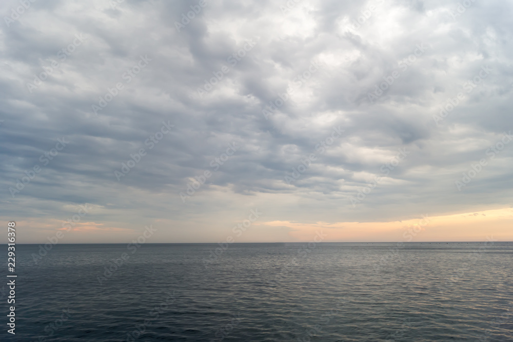 Cloudy sunset over the Black Sea in summer evening Cloudy sunset over the Black Sea in summer evening