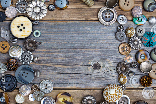 placer of vintage buttons with copy space on textured old boards