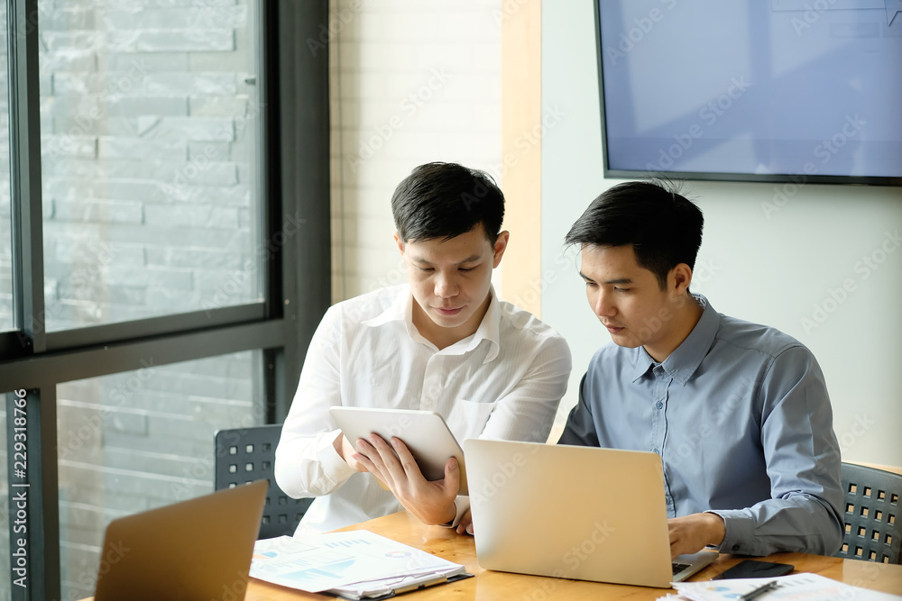 Business partner, A man working with laptop computer and digital table. Business partner, A man working with laptop computer and digital table.
