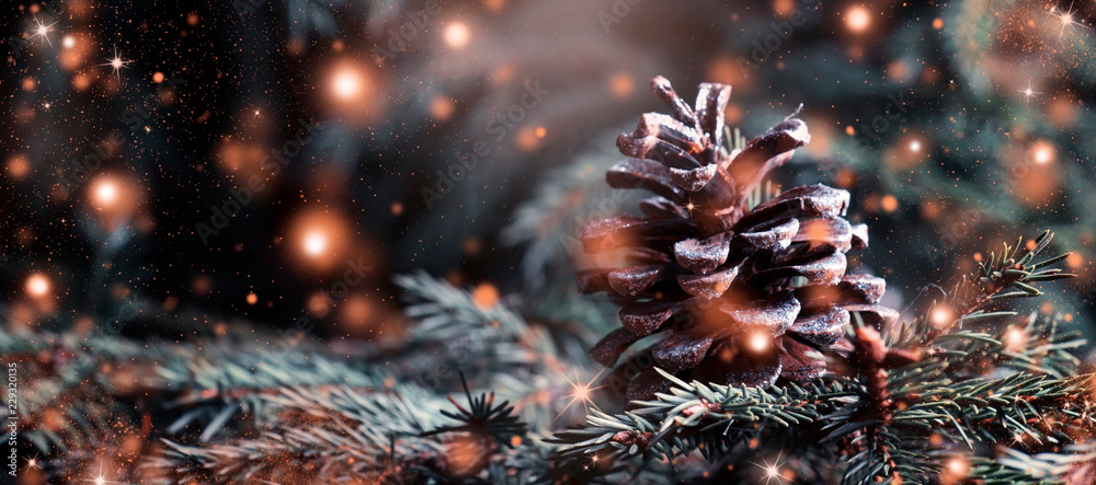 Christmas or New Year blurred snow background with festive fir tree and pine cones, selective focus - obrazy, fototapety, plakaty 