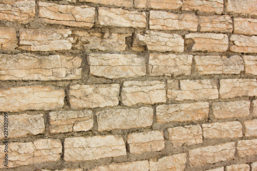 Old wall of rubble masonry. Rubble stone. Part of the ancient wall, fortress.