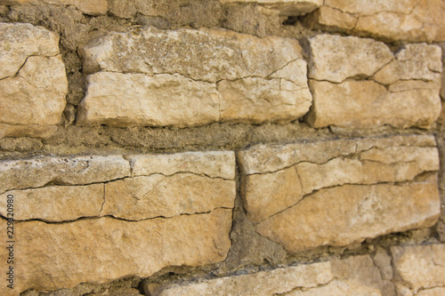 Old wall of rubble masonry. Rubble stone. Part of the ancient wall, fortress.