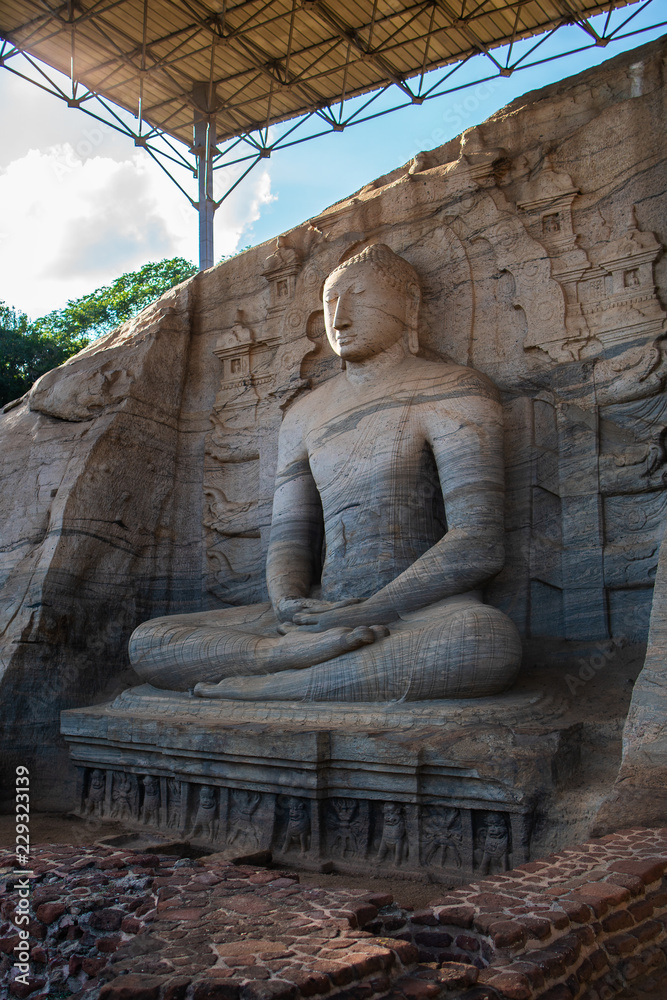 The stone image of Buddha Gautama in dhyana mudra, located in Gal Vihara of the area in the neighborhood of the ancient capital of Sri Lanka - the city of Polonnaruwa.