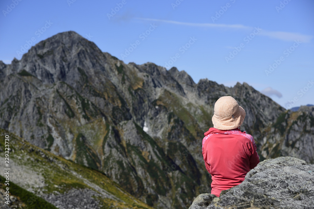Female trekker looking at Mt.Tsurugidake during rest