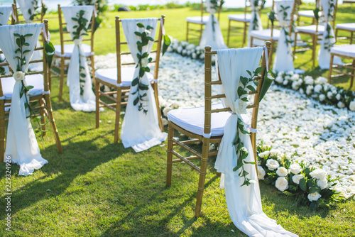 Chair decorated with flowers in Wedding ceremony.