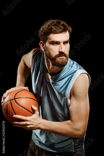 Confident basketball player on black