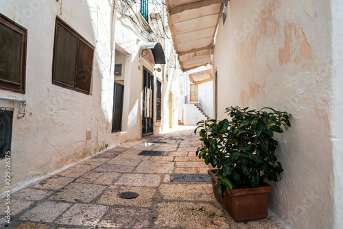Little alley in the medieval center of the white village of Cisternino
