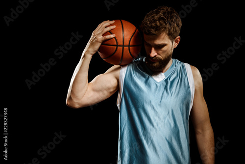 Basketball player posing with ball © yuriygolub