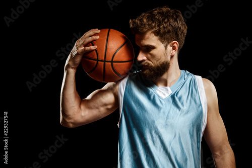 Handsome man posing with basketball
