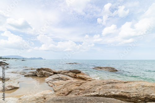 rocks on the beach with cloudy blue sky © mas042