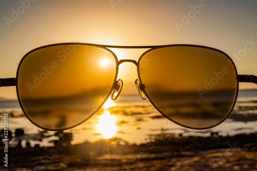 Sea and sky through sunglasses at sunset